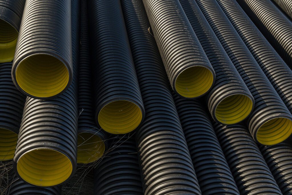 black corrugated plastic pipe on construction site Coastal Resources Group