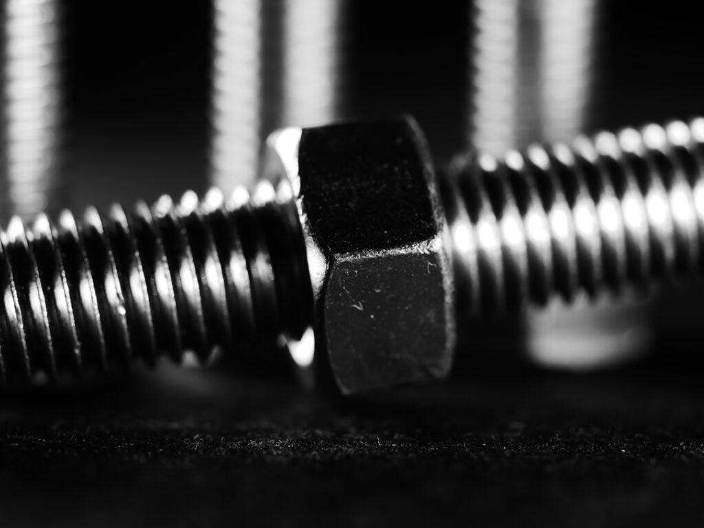 closeup shot of metal screw threads isolated on the black background 2 Coastal Resources Group