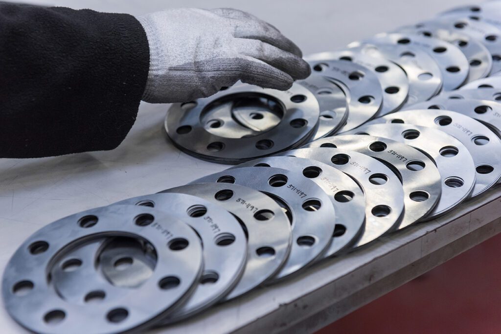 engineers hand arranging cut parts in engineering factory close up Coastal Resources Group