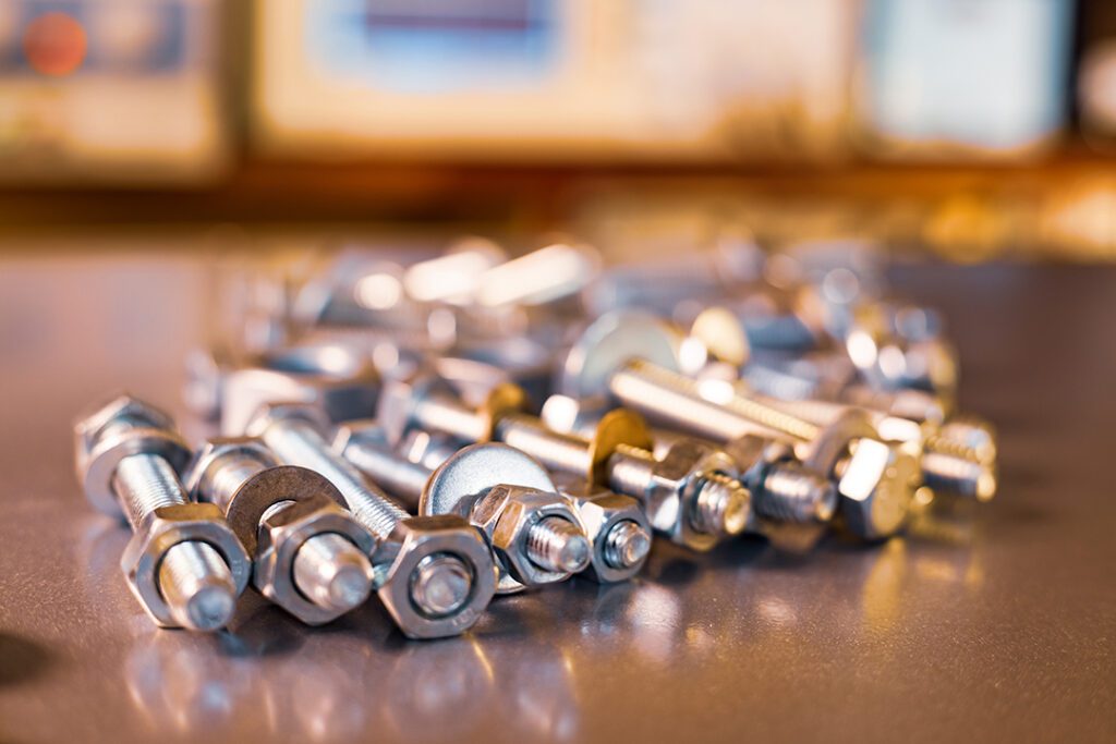 metal chrome bolts and nuts in a chaotic order industrial background Coastal Resources Group