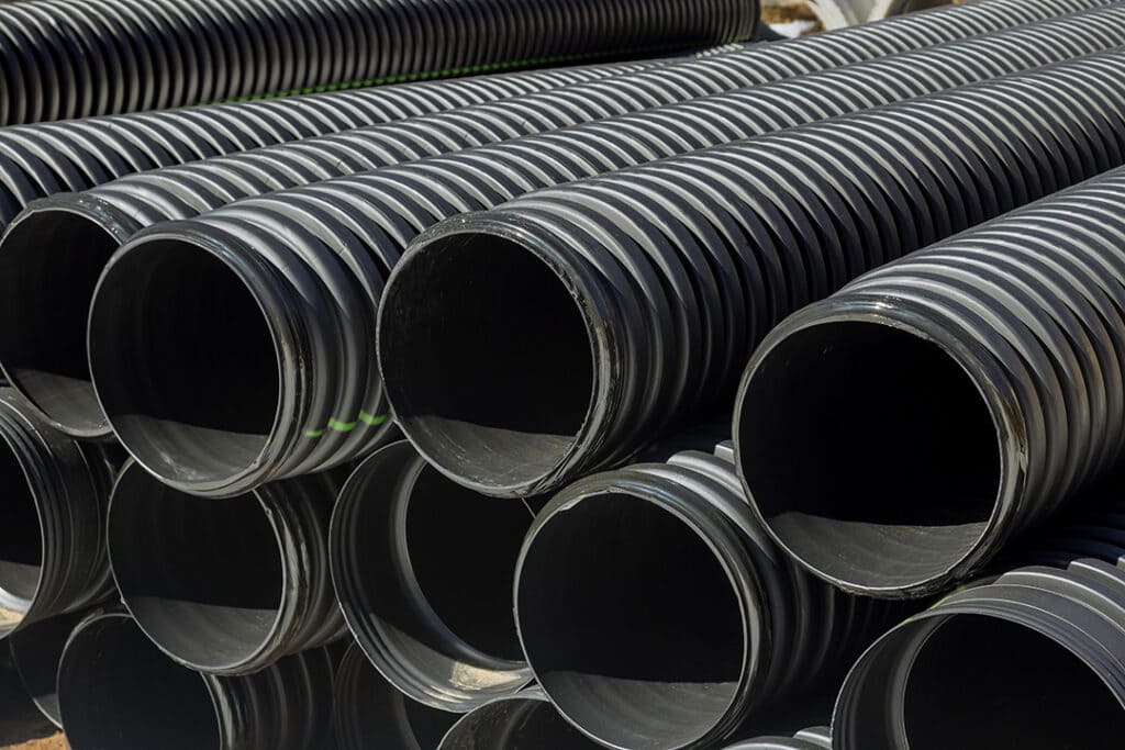 pvc tubes plastic pipes stacked in rows at construction Coastal Resources Group