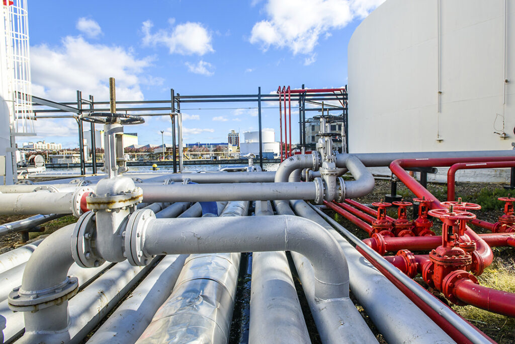 silver and red industrial piping and valves Coastal Resources Group