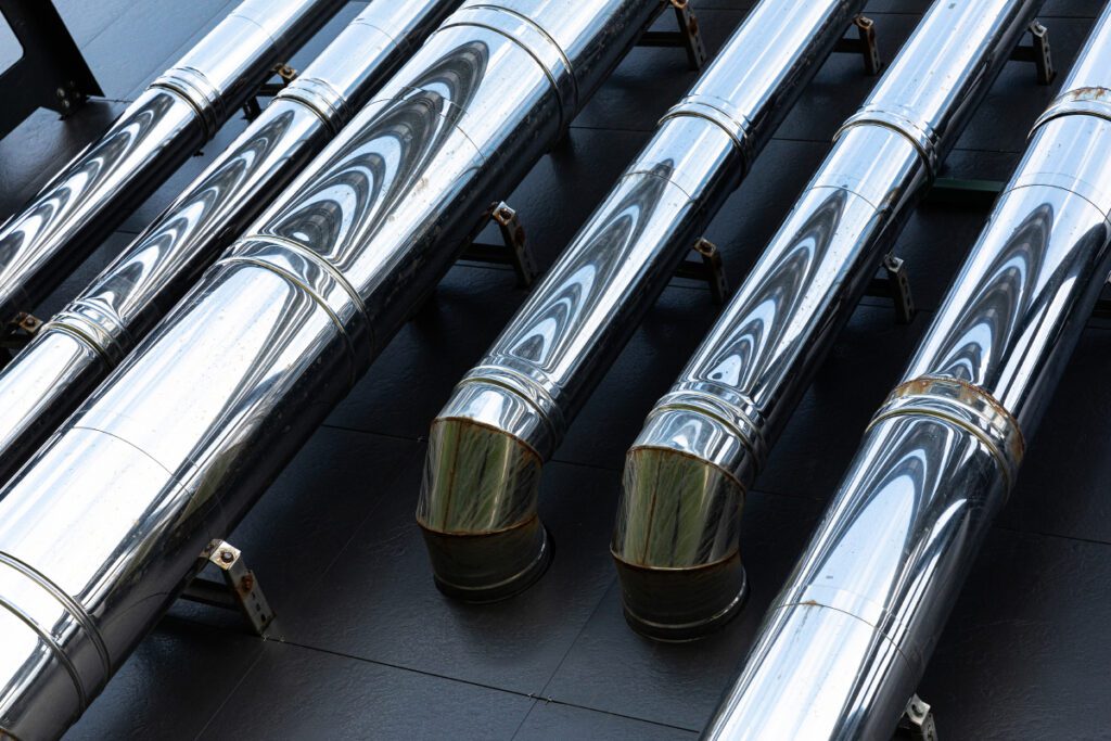 stainless steel pipes close-up on the wall of an office building