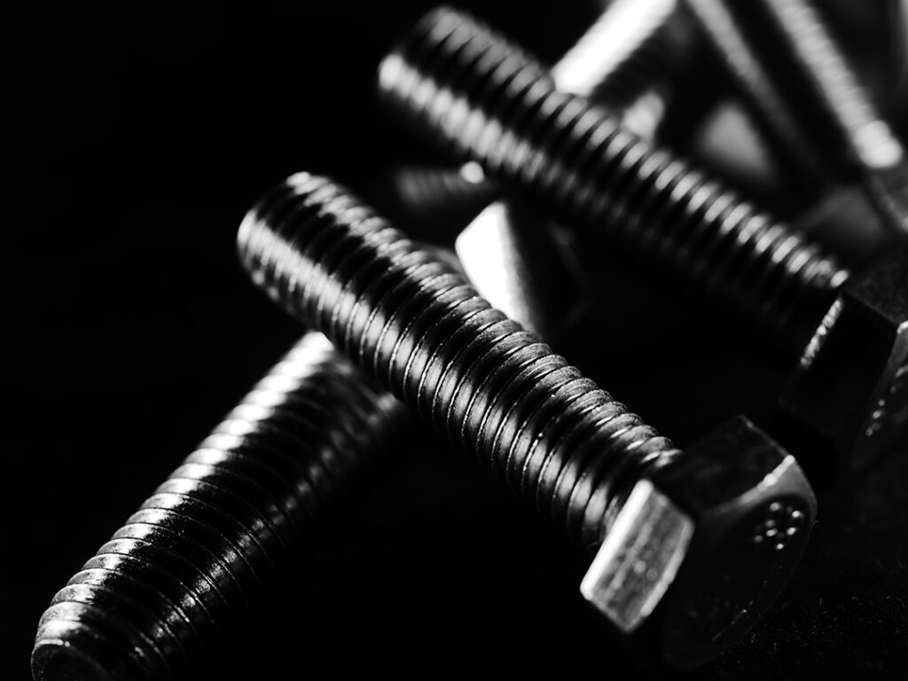 studio grayscale of screws on black background Coastal Resources Group