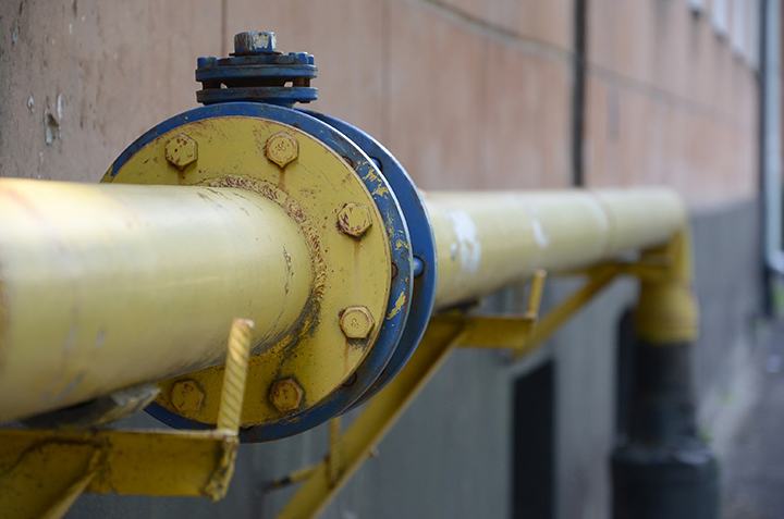 yellow gas pipe in front of residential building wall Coastal Resources Group